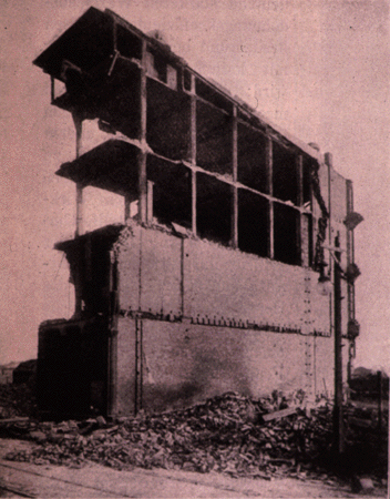 a wrought iron frame building standing among the ruins of many other buildings after a fire in Baltimore, Maryland around the turn of the century
