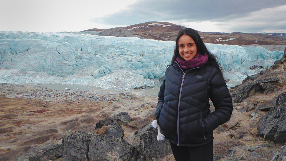 Meghana Ranganathan standing next to a large ice flow