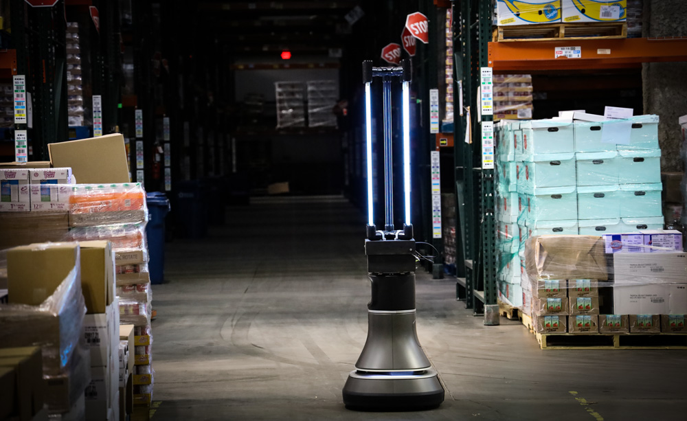 a disinfecting robot in the middle of a warehouse