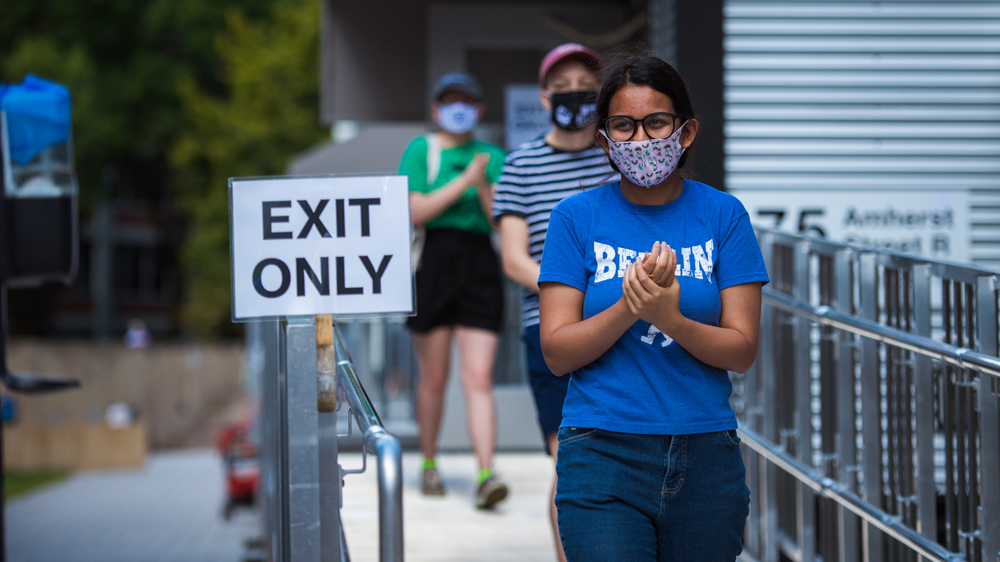 Students exit the Covid-19 testing trailer upon arrival at MIT campus