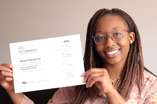 Abigael Bamgboye holding her MITx MicroMasters certificate