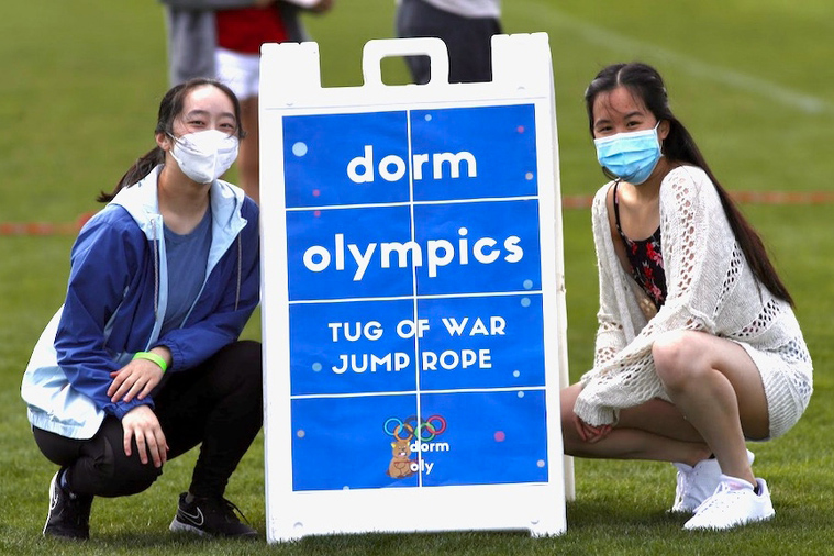 MIT students with "dorm olympics" sign