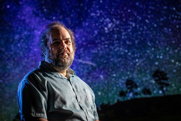 Andy Rivkin against a night sky