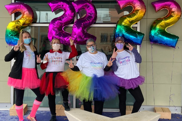 four women in tutus with number two balloons