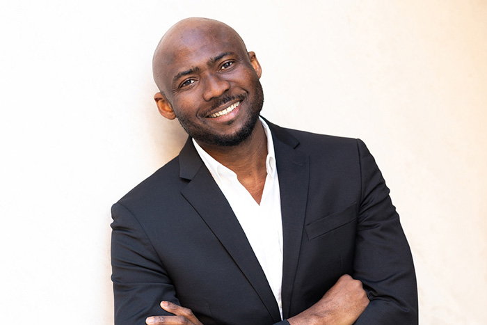 Photo of Lawrence Udeigwe in front of white wall