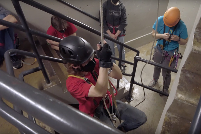 a group of students caving in a stairwell
