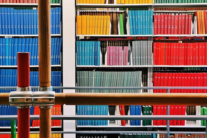 Artistic photo of colorful books and pipes at MIT Roch Library, by j_sarinana 