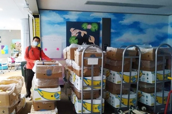 Student poses with lots of bananas in the Banana Lounge