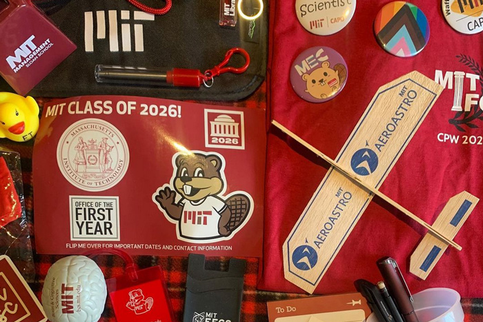 Campus preview week swag includes MIT stickers, buttons, pride flag, and club pins 