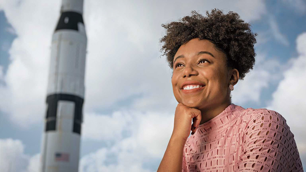 Photo of Tiera Fletcher with rocket in background