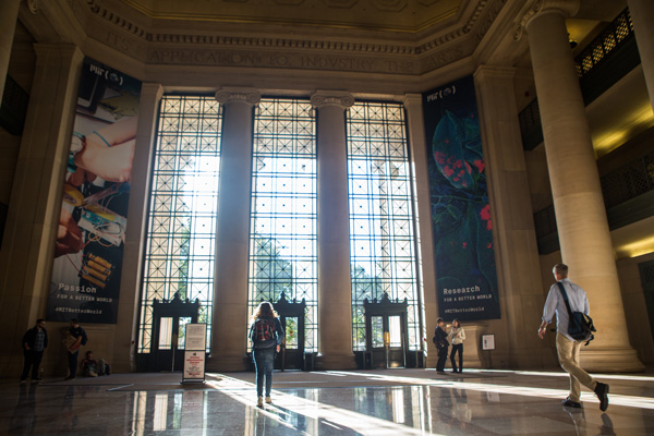 Several people walking through Lobby 7 at MIT