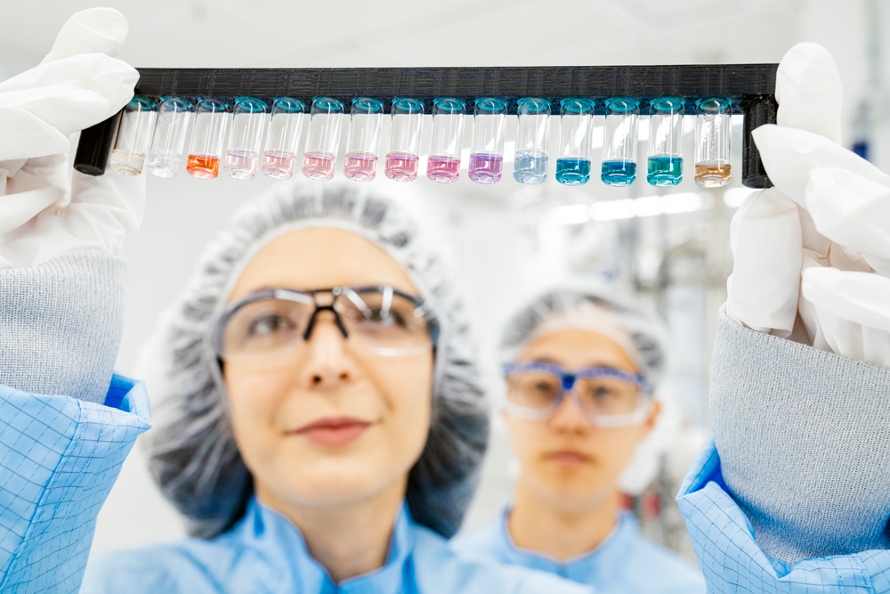 Farnaz Niroui and Spencer Zhu look at a multi-colored array of nanoparticles suspended in water