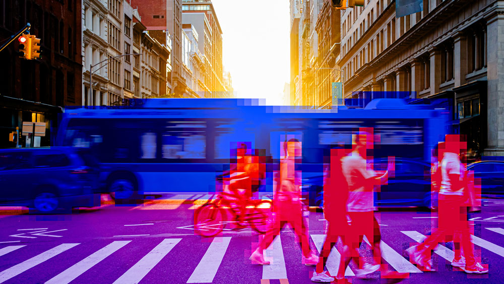 A busy city intersection where a bus is colored blue and pedestrians are colored red.