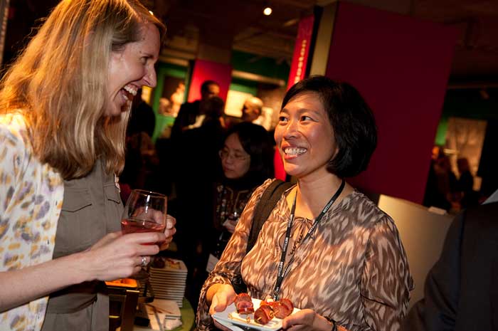 Retired Commander Catherine Kang MBA ’06, right, chats with a woman at an MIT party