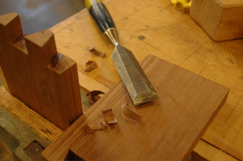 Chisel and dovetailed wood