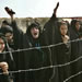 An Iraqi woman screams as she waits with others outside the prison in Abu Ghraib, outside Baghdad, Iraq, Sunday, May 2, 2004. Hundreds of Iraqis who have relatives being held in the prison of Abu Ghraib demanded to see them after the release of shocking pictures showing prisoners being humiliated by their U.S. captors. (AP Photo/Anja Niedringhaus)