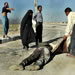 An Iraqi man, left, gestures as other Iraqis rescue the dead body of an Iraqi soldier outside the Technical College of Basra, on the outskirts of this southern Iraqi town, Thursday, April 03, 2003. British forces launched an earlier an attack on Iraqi forces around Basra. (AP Photo/Anja Niedringhaus)