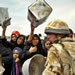 Iraqi women reach out with empty water baskets as British soldiers arrived to supply the outskirts of Iraqi's southern city of Basra with drinking water, Friday,  April 04, 2003. (AP Photo/Anja Niedringhaus)