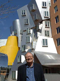 Mitchell stands in front of the Ray and Maria Stata Center, one of several buildings in his new book