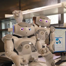Student working in lab with robots