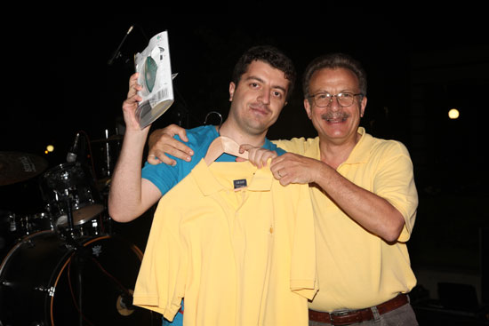 At SU Alumni Reunion, the President's yellow t-shirt goes as scholarship fund lottery prize to Metin Tabalu (SU 2003) (3 July 2010).