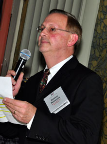 QCC Vice President Norman Magnuson greets members at the 2012 winter holiday gathering.