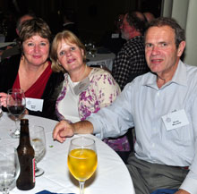 Peggy Shea, QCC board member June Milligan, and Kevin Milligan enjoy some friend time at the QCC holiday party.