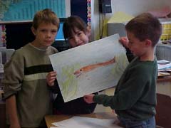 Students holding up a drawing