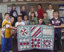Students with Mattie's gift, a quilt