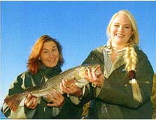 Two females holding a fish