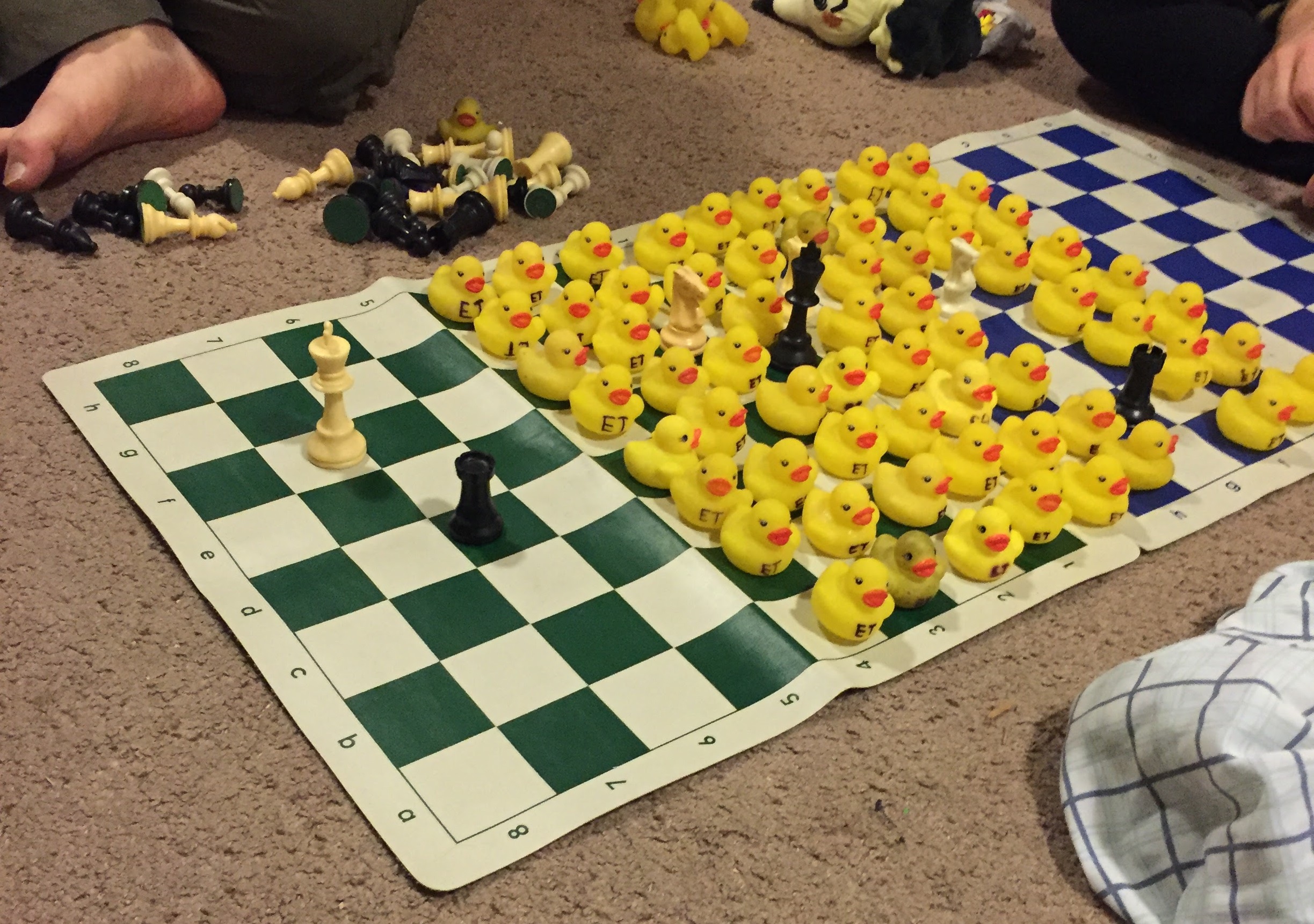 A chess board full of rubber ducks