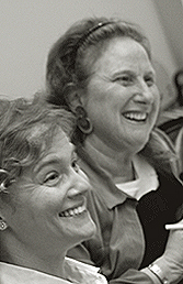 two smiling faculty members looking engaged and happy