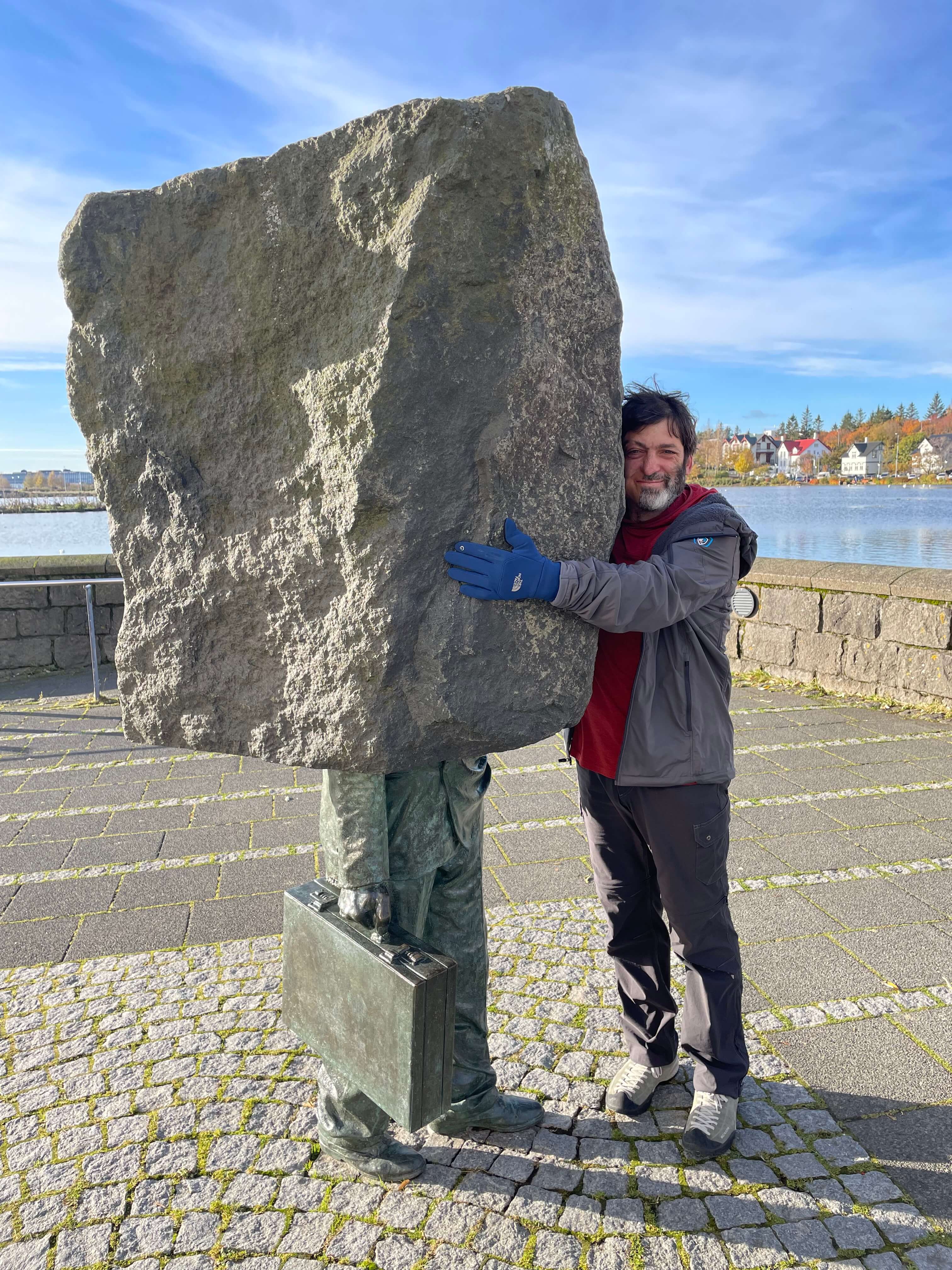 Dan Ariely standing next to a giant rock