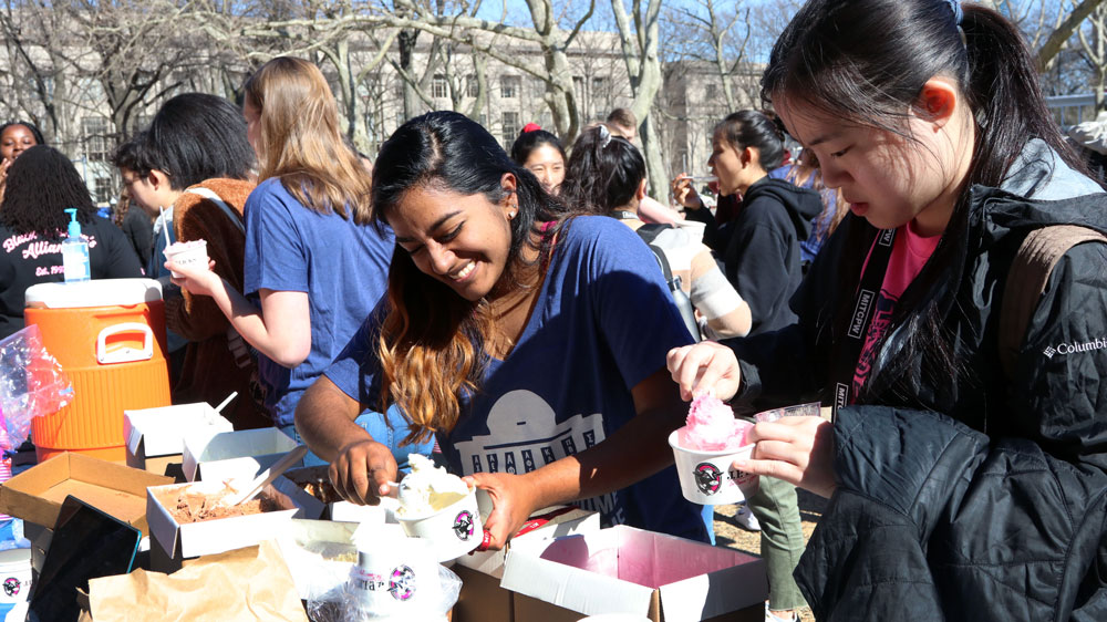 MIT student scooping ice cream during Campus Preview Weekend