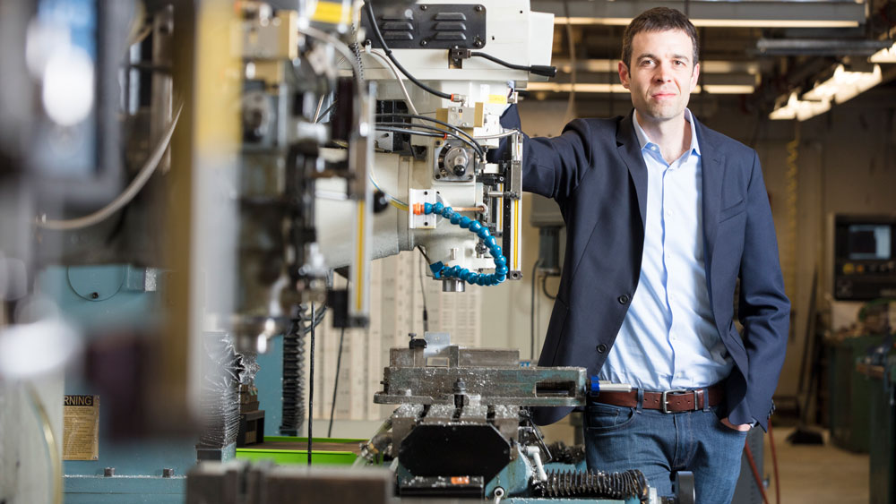 An image of John Hart standing in his lab at MIT