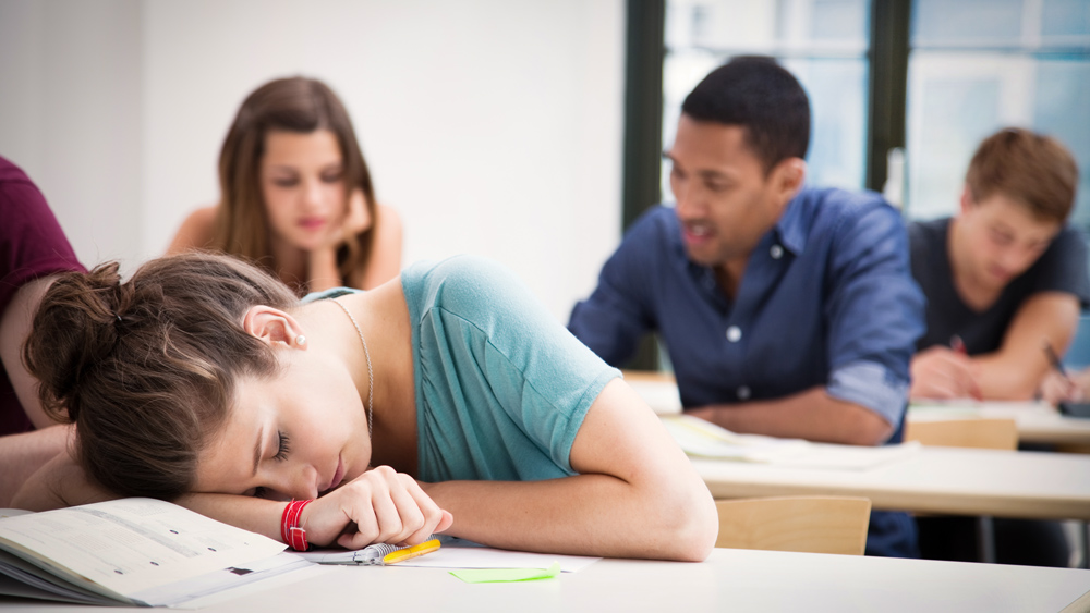 An image of a student sleeping in class