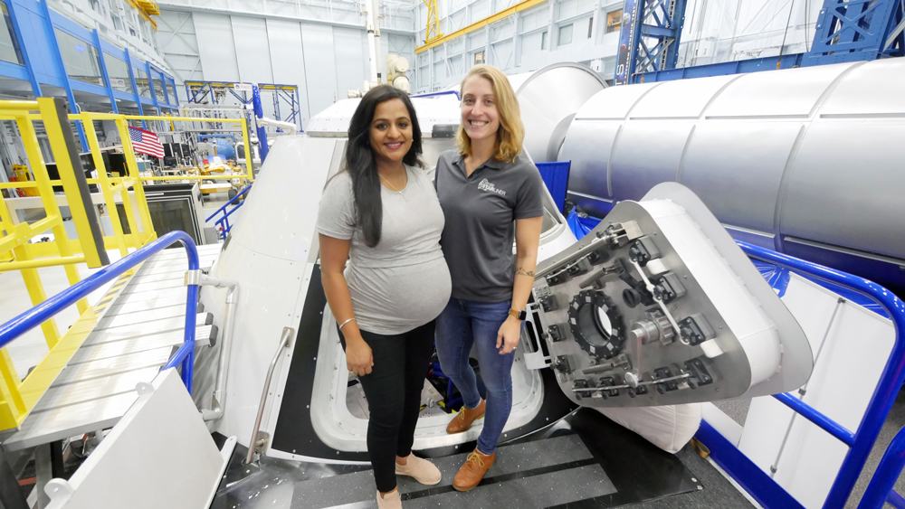 Kavya Manyapu SM ’10 and Celena Dopart SM ’14 with Boeing's Crew Space Transportation (CST)-100 Starliner spacecraft