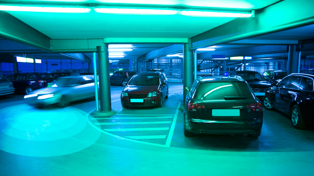 An image of an autonomous car driving in a parking garage 