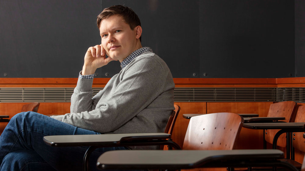 A portrait of Semyon Dyatlov sitting in a classroom