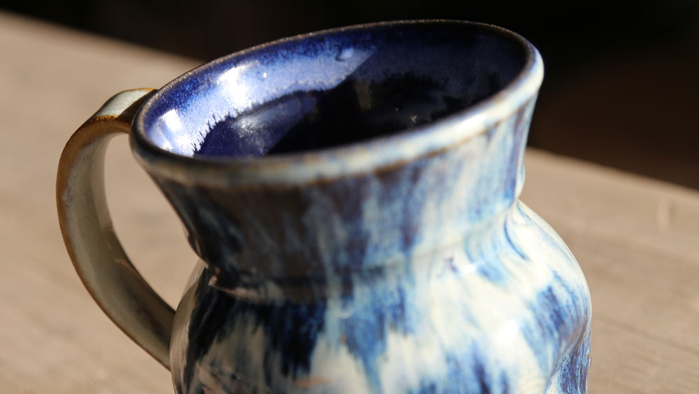 An close up image of a blue and white mug