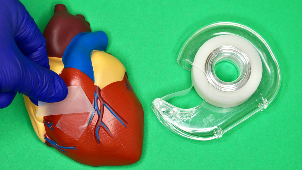 photo of a toy heart with a piece of tape, and a tape holder