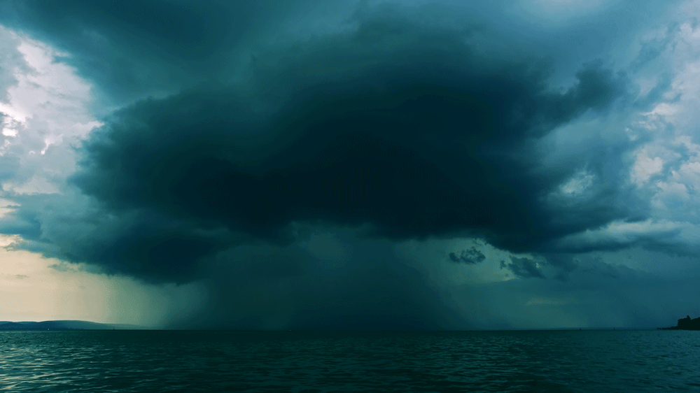 an animation showing a super cell thunderstorm over the ocean with lightning striking the water