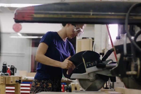 Emily Skilling working with a table saw at MIT