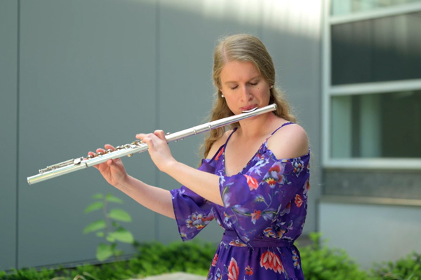 Sara Simpson playing a flute outside at MIT