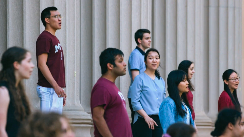 MIT student singers singing on outdoor steps at MIT