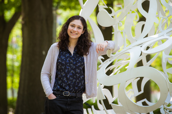 PhD student Sarah Nyquist next to The Alchemist sculpture