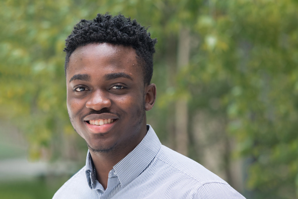 Awele Uwagwu standing outside in front of trees