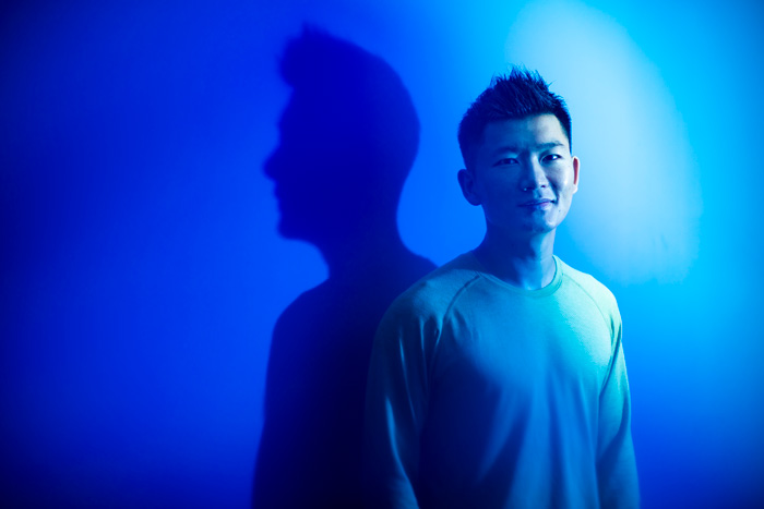 Photo of Hank Yang bathed in blue light