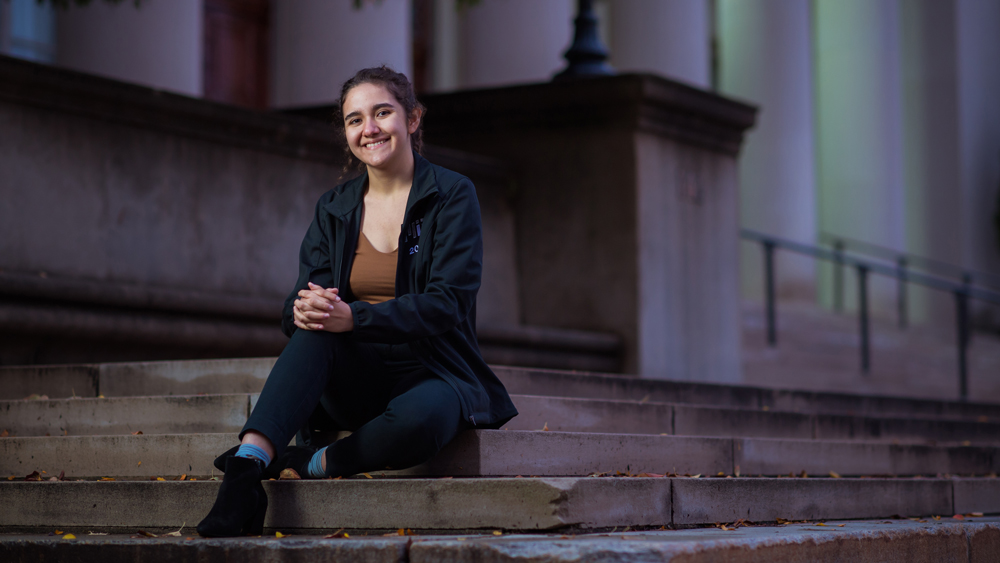 Photo of Senior Ana Reyes Sanchez sitting on steps outside of Lobby 7