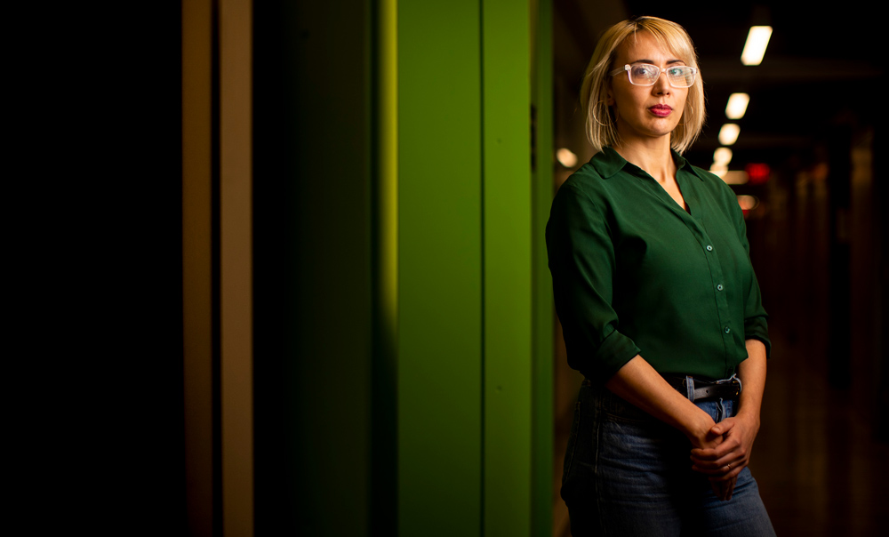 Photo of Kerstin Perez standing next to green wall 